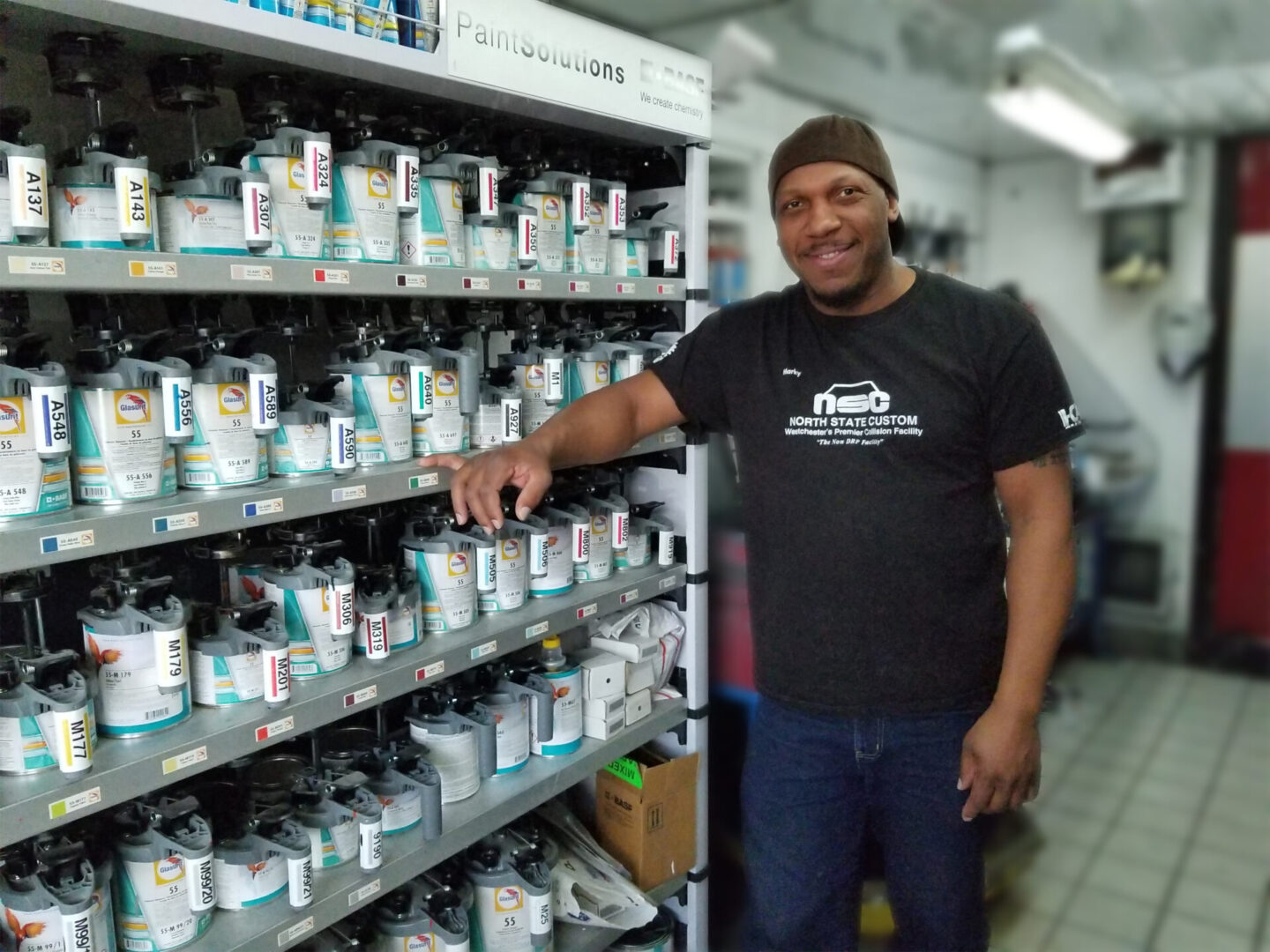 Man smiling while organizing products on store shelves. Man smiling while organizing products on store shelves.